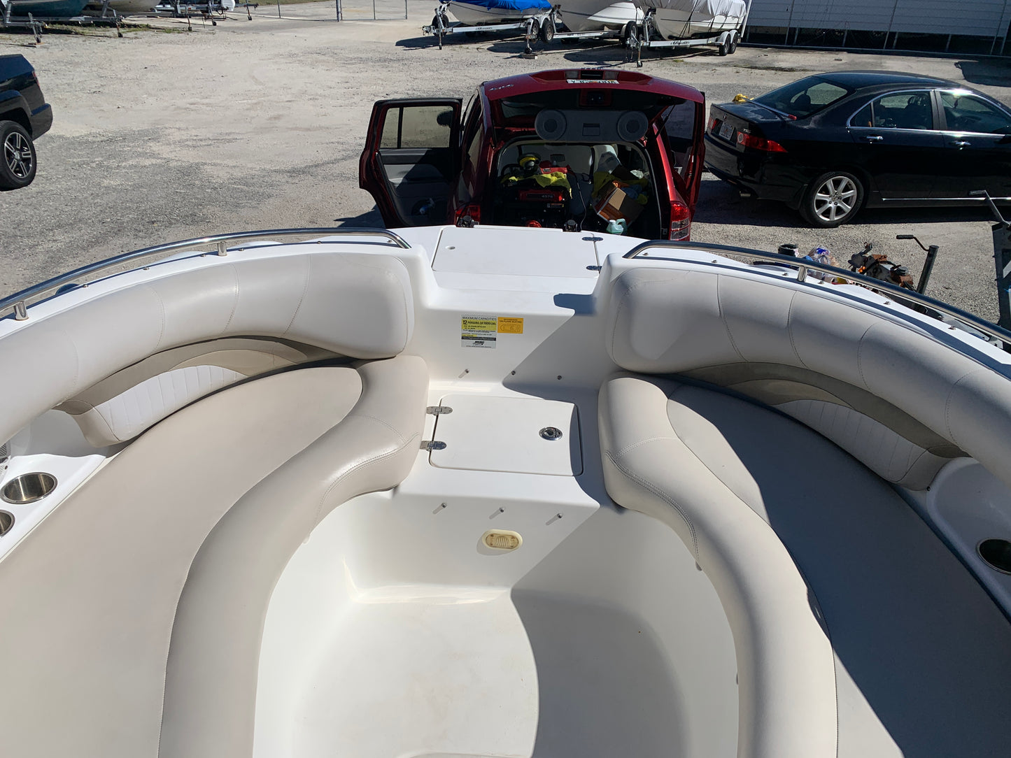 Bow portion of the boat with my old detailing van in the background, showcasing the clean, restored finish after detailing.