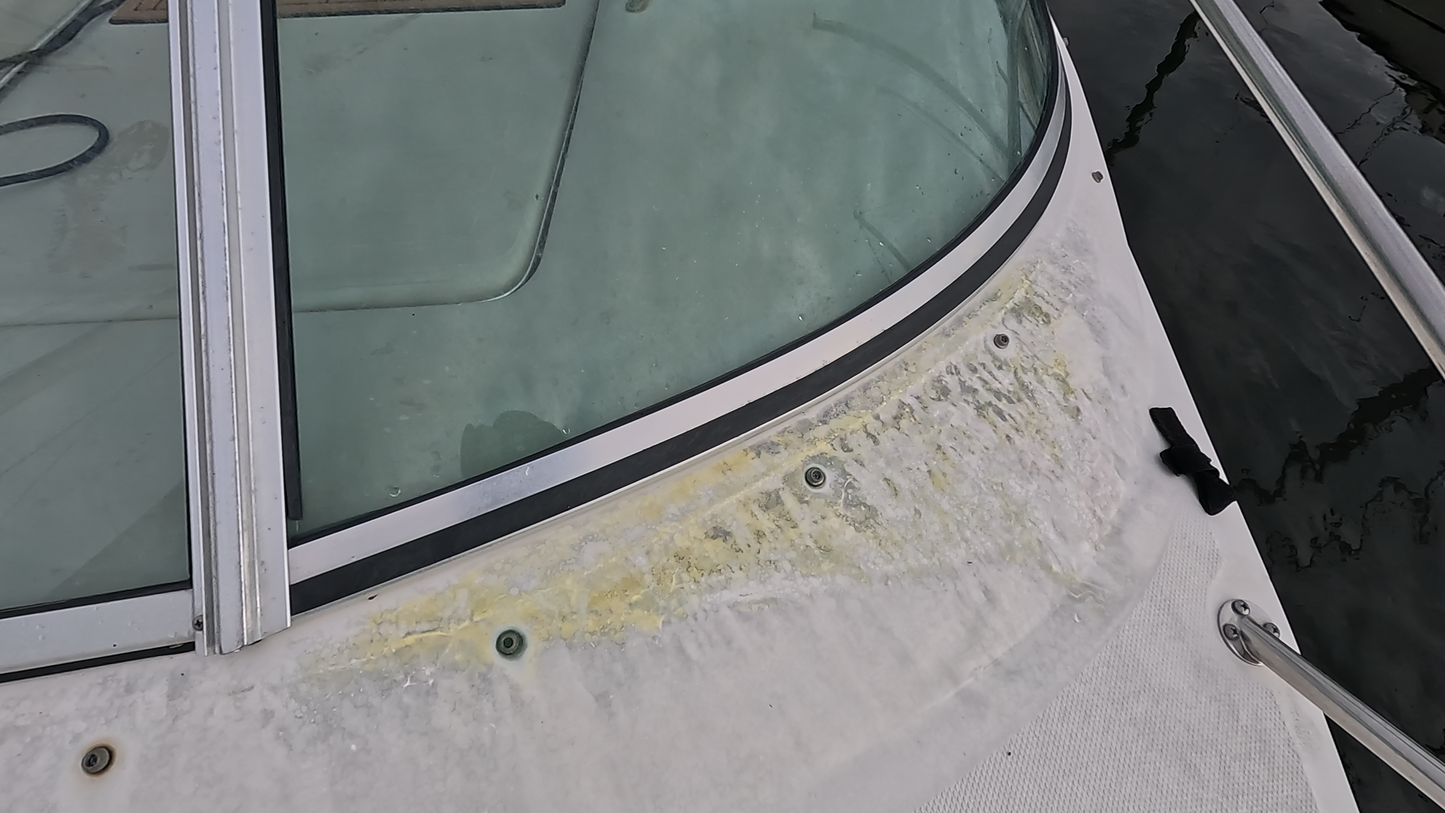 Before image of oxidation on the boat’s bow, showing the flat front surface with visible signs of wear and dullness.