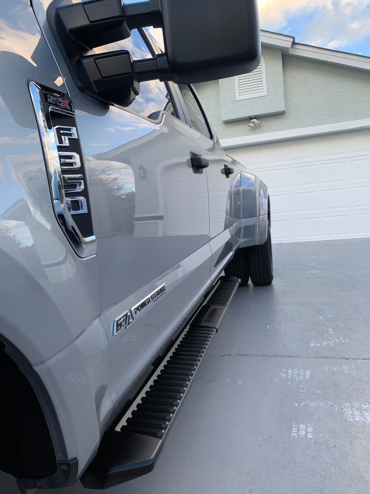 Close-up of the Ford F350's paint, showing a clear reflection of the house, after our professional detailing service.