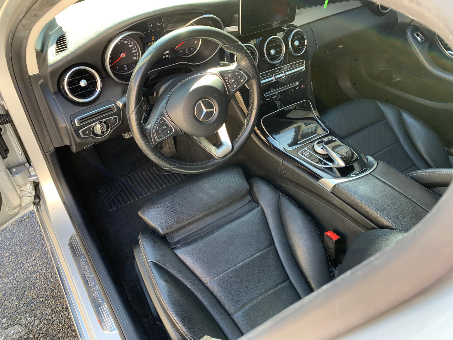 Mercedes-Benz interior after a deep clean, with the steering wheel and center console looking brand new and freshly coated.