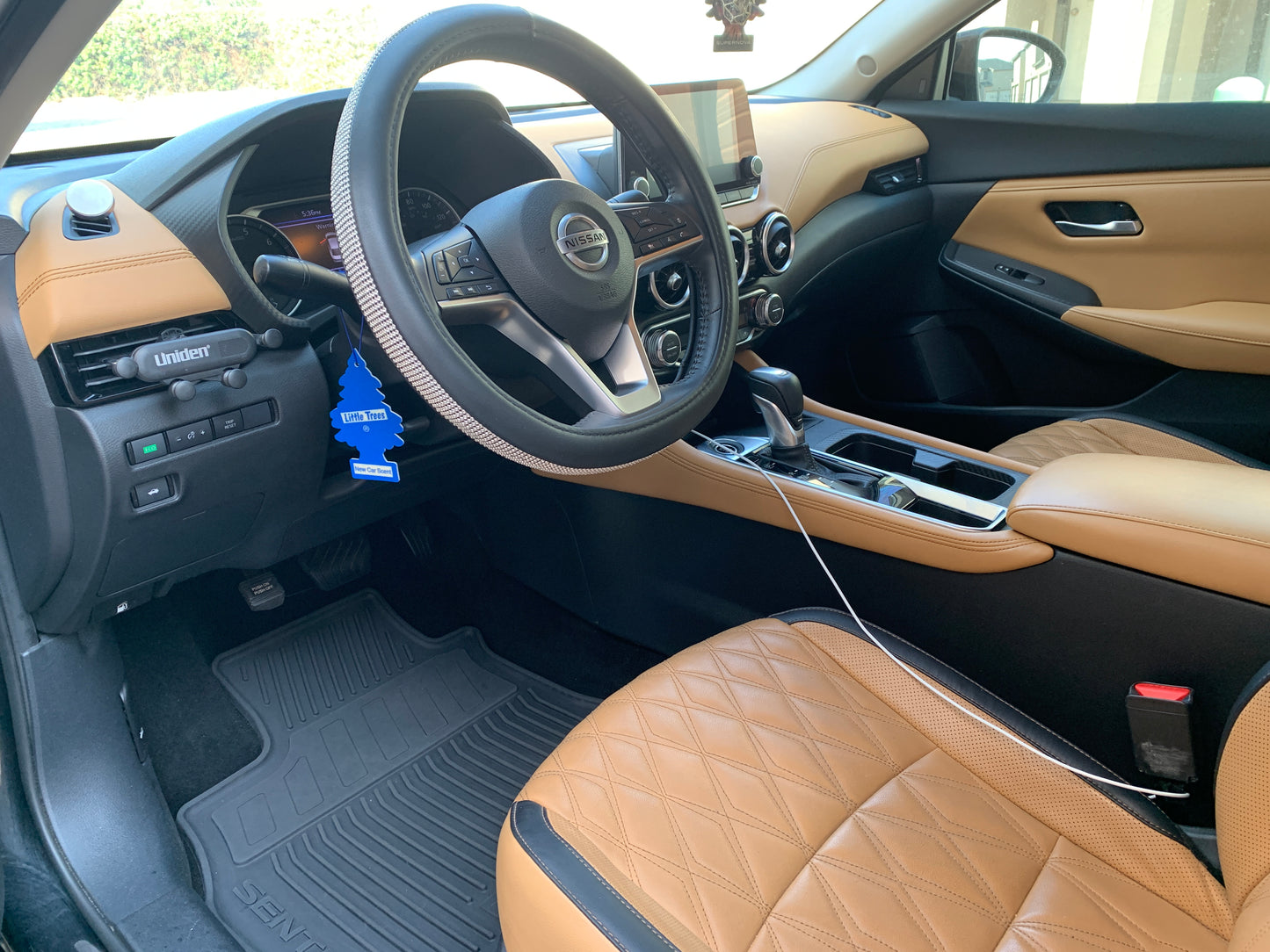 A close-up of a vehicle's interior after deep cleaning, highlighting the rejuvenated leather seats and spotless surfaces