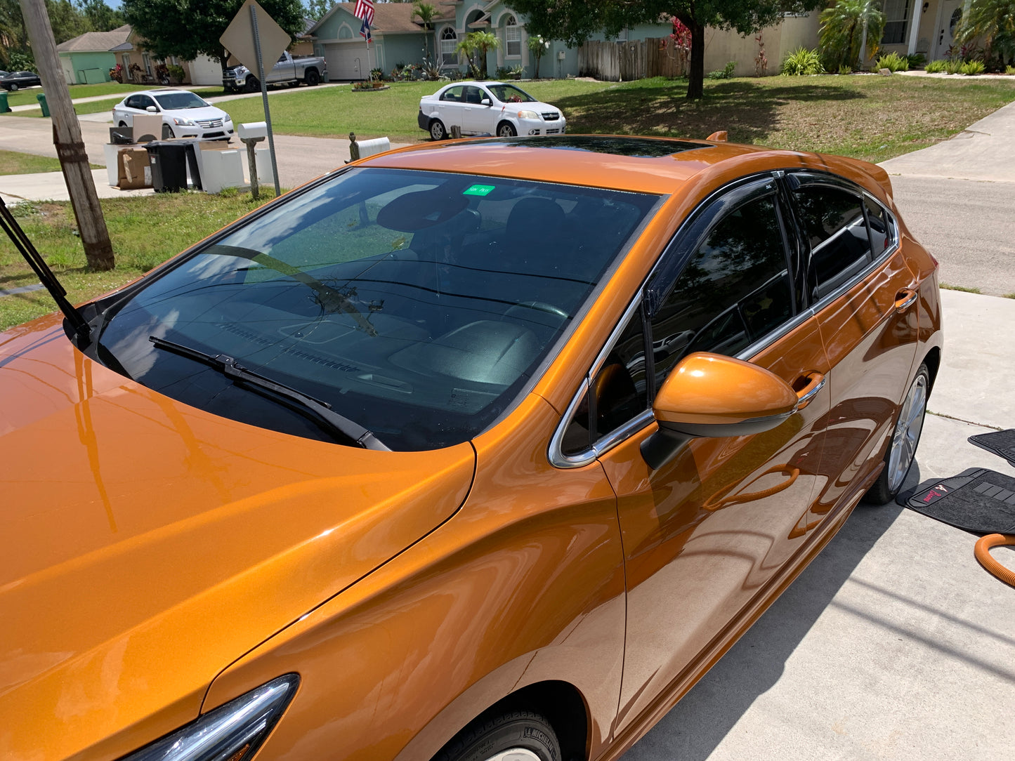 Top-down view of the orange Chevy after our paint enhancement, showcasing the clean and shiny surface.