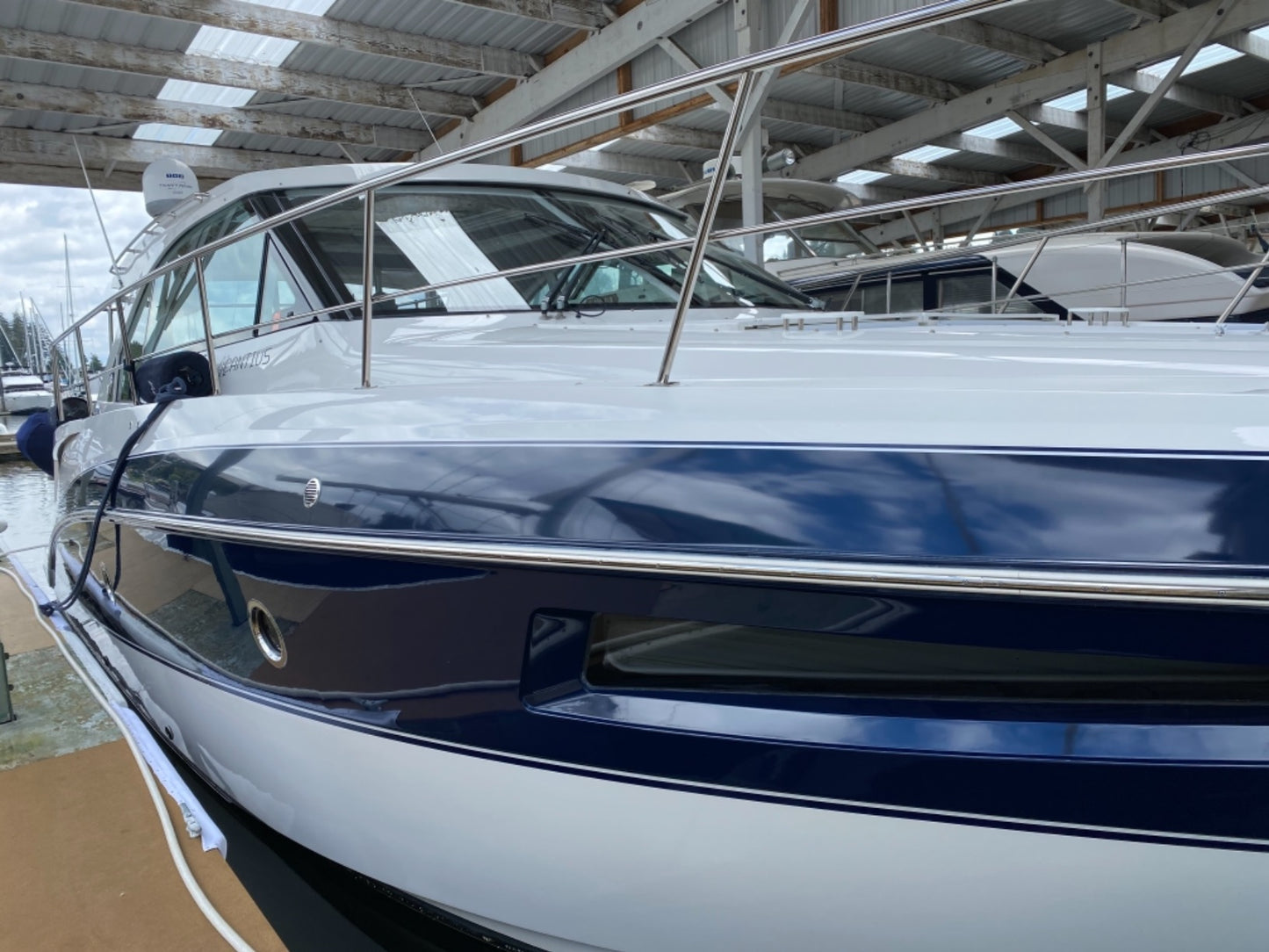 Starboard side of the yacht after paint correction, showcasing a flawless, reflective finish post-oxidation removal.