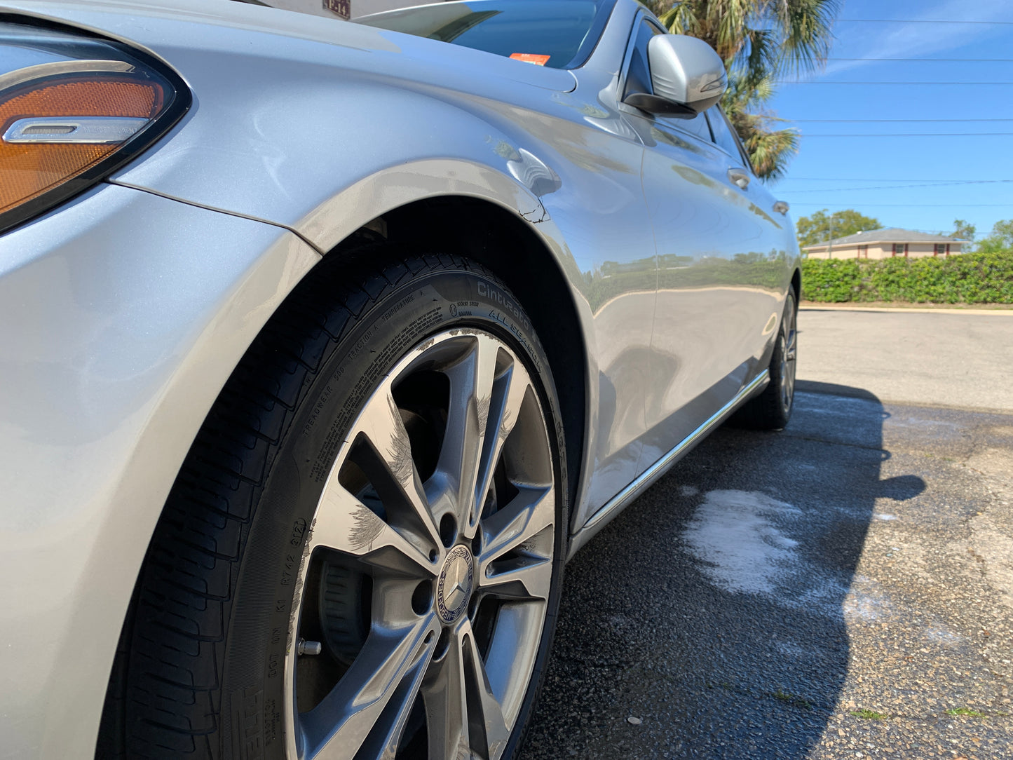 Low front shot of a Mercedes after our 2-stage paint correction, showcasing the sleek finish.