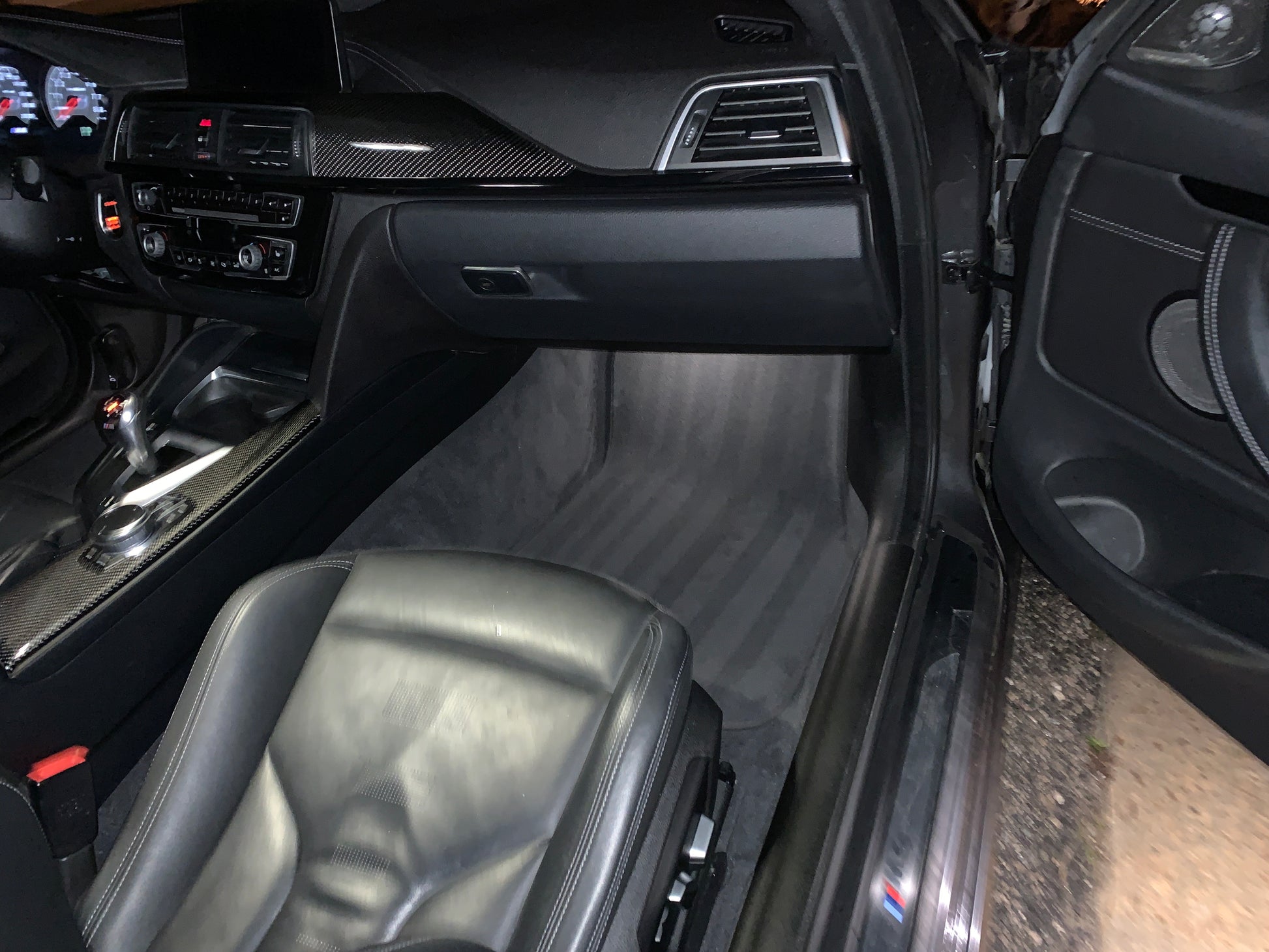 BMW M4 with clean carpet line art patterns after our detailing service, showcasing the meticulous attention to detail.