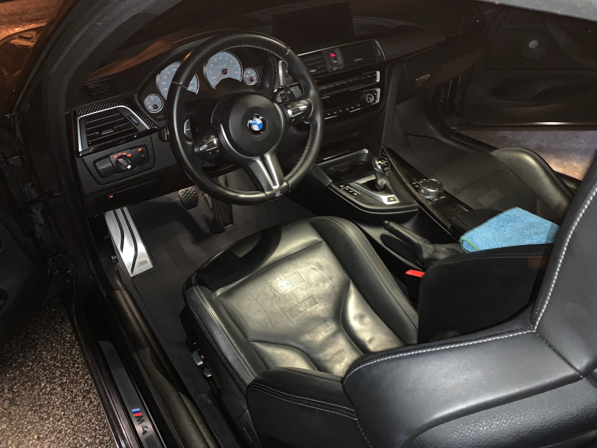 Interior view of BMW M4 from the driver’s side, showcasing the detailed and clean interior after our professional detailing service.