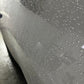 Detailed shot of water beading on a white car, highlighting the hydrophobic properties of graphene ceramic coating