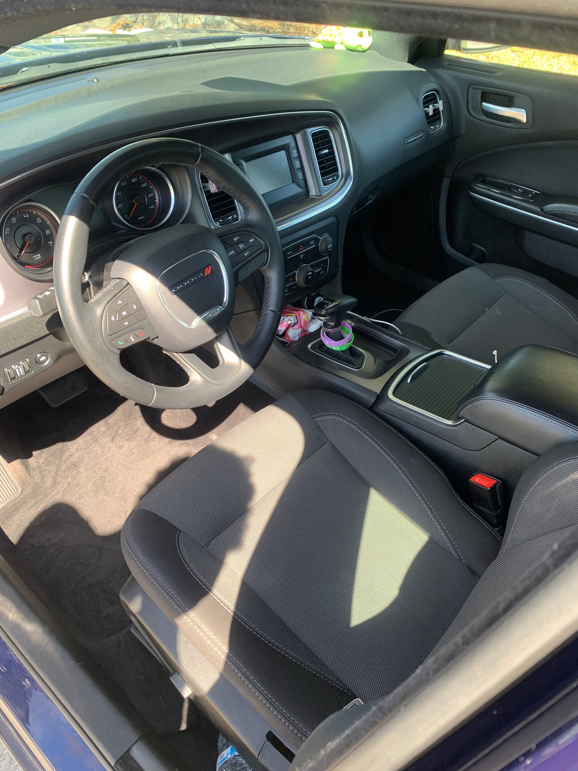 Interior of the blue Dodge Charger looking brand new, with a pristine dashboard, clean seats, and detailed surfaces.