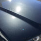 Close-up shot of the classic BMW's hood, showing paint speckling in the sun after our 2-stage paint correction package.