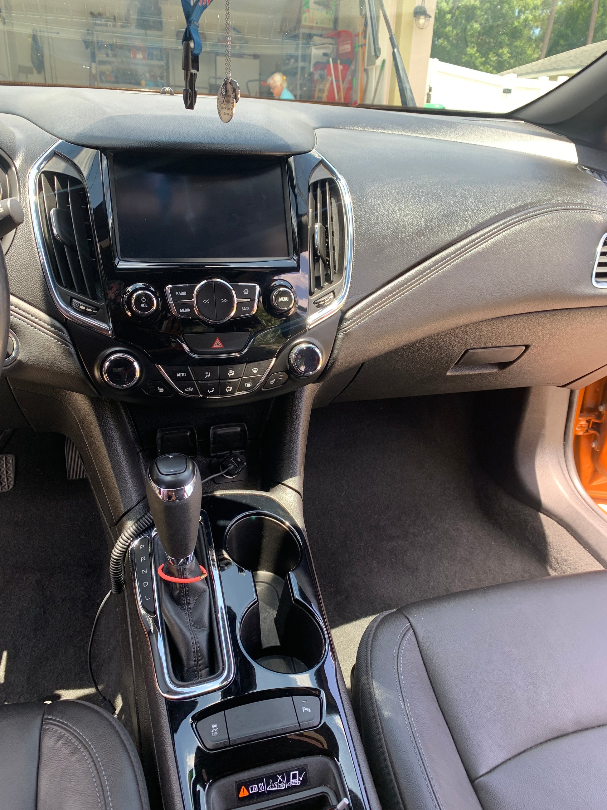 Cleaned and coated dashboard and center console of a vehicle after detailing.