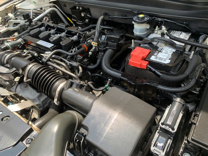 Deep-cleaned engine bay with rejuvenated plastic components, showcasing a like-new appearance.