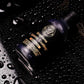 Close-up of graphene ceramic coating bottle resting on a vehicle hood with water beading on the surface.