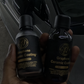 Detailer holding two bottles of graphene ceramic coating at Finishline Detailing Garage LLC in Tallahassee, FL, showcasing premium protective products for automotive finishes.