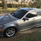 Side view of the gray Mercedes after a paint enhancement service at Finishline Detailing Garage LLC. The FSU sticker is visible on the rear window, with the vehicle's paint reflecting a high-gloss finish after the two-stage paint correction.