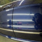 Left side of the blue Mercedes, reflecting me, the shop, and detailing tools, after a two-step paint correction that restored the glossy finish