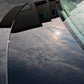 The trunk of a limited edition Mercedes reflecting the clouds and sun, showcasing the glossy finish after paint correction and ceramic coating.