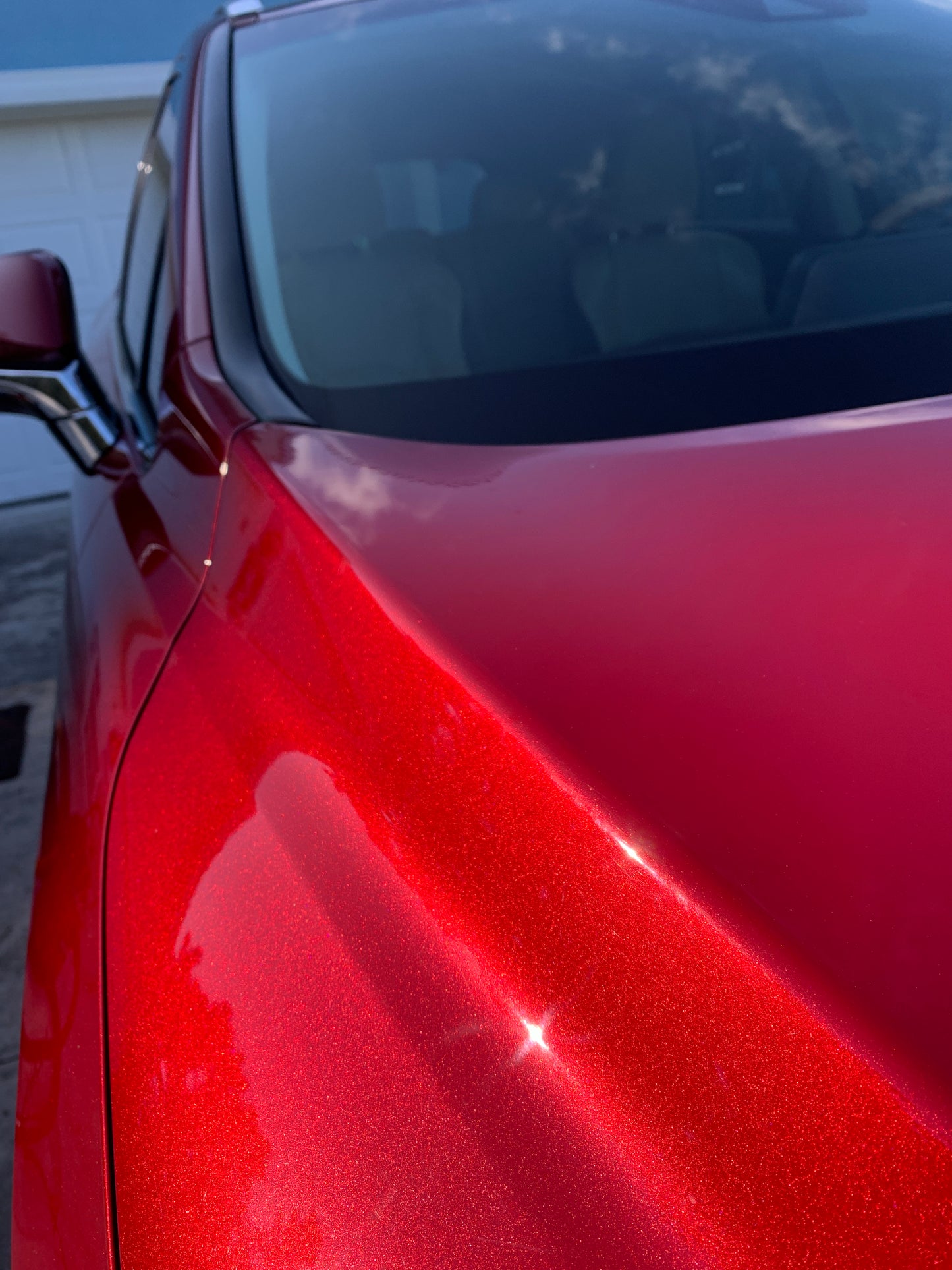 Close-up of the red Lexus R350 SUV's paint, showing paint sparkling after our two-stage paint correction and graphene ceramic coating.