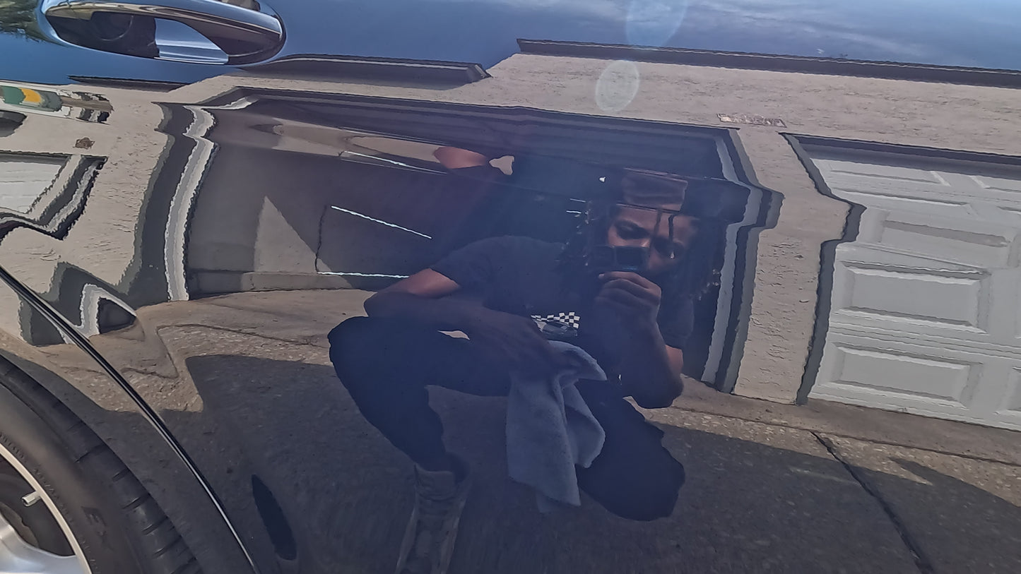 Reflection of the technician in the flawless, high-gloss finish of a limited edition Mercedes after paint correction, showcasing the remarkable results of the service.