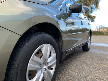 Green Subaru Outback after detailing the exterior and applying our ceramic wax, showcasing a shiny and well-protected surface.