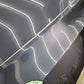 Tesla quarter panel after professional paint correction, showcasing a smooth, glossy finish with imperfections removed