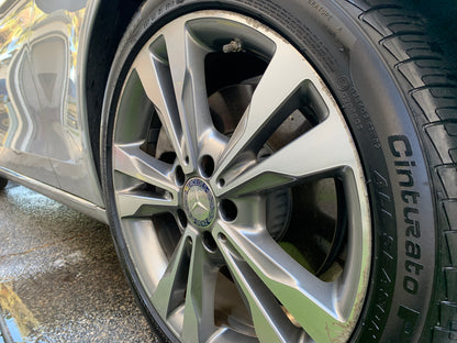 Close-up shot of a shiny, detailed wheel with a protective ceramic coating applied, showcasing its brand-new appearance."