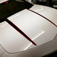 White Camaro hood after a paint enhancement, showcasing a glossy and reflective finish.